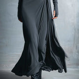 Charcoal gray draped maxi dress close-up with ruched knot and layered skirt folds