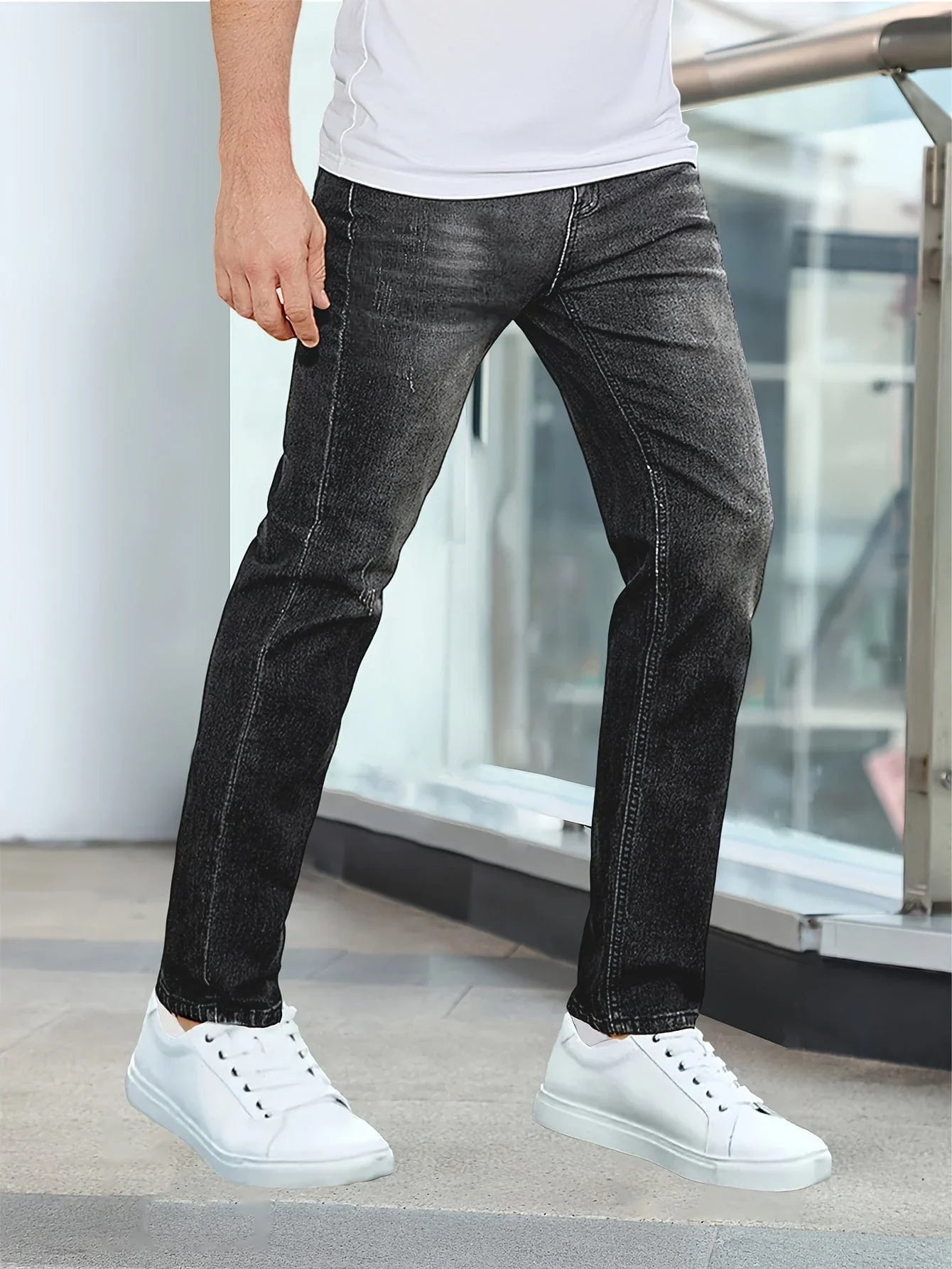 Black casual stretch jeans with straight legs, five pockets, and belt loops