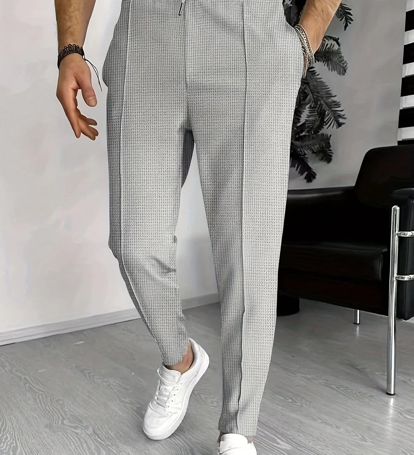 Gray checkered sports pants with elastic waistband and drawstring, tapered legs