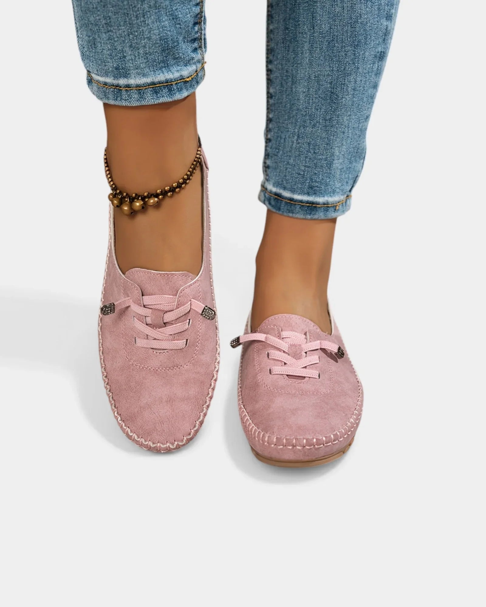 Pink suede lace-up loafers with stitched trim and rounded moc toe.