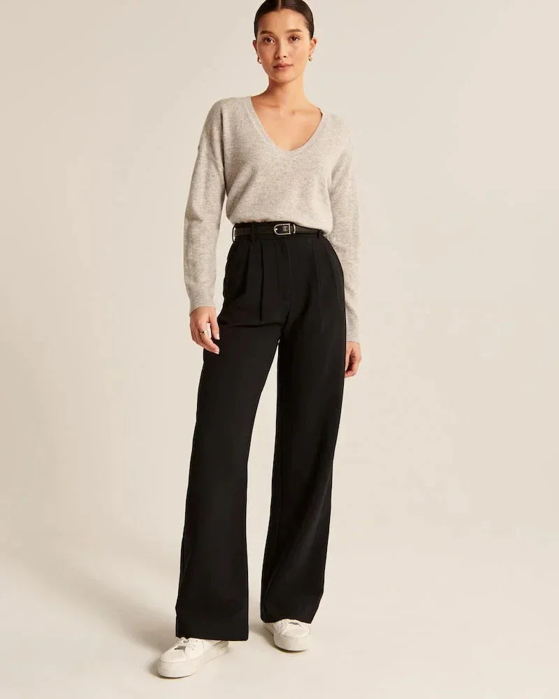 Black pleated front wide-leg trousers with belt loops and relaxed straight legs