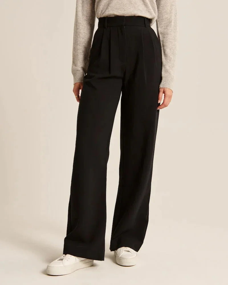 Black high-rise wide-leg pants with pleats and belt loop waist, side view