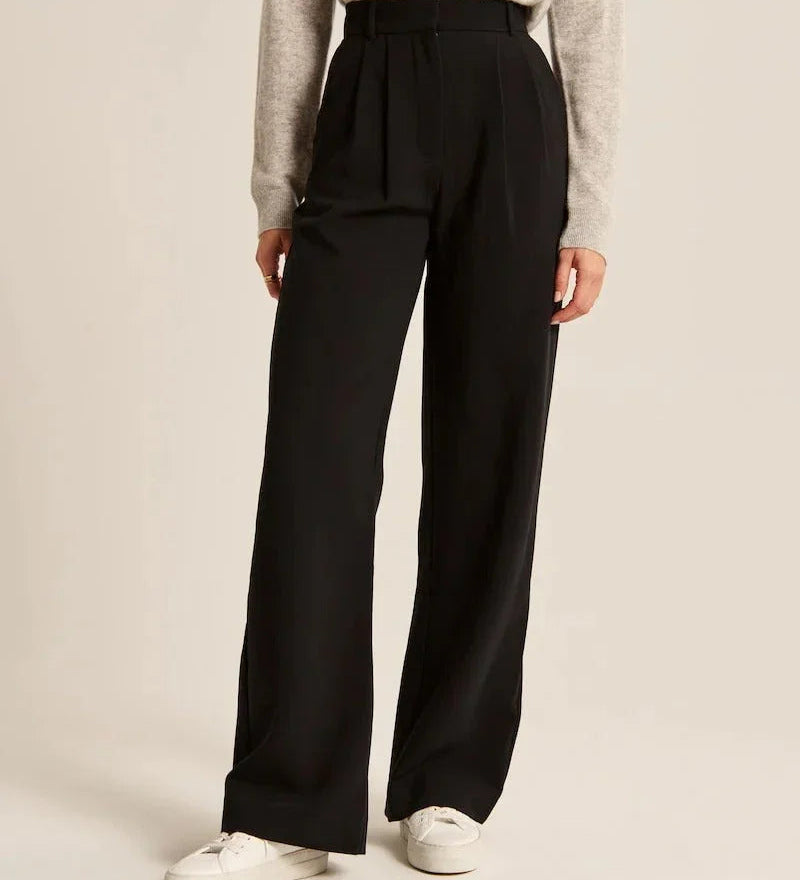 Black high-rise wide-leg pants with pleats and belt loop waist, side view