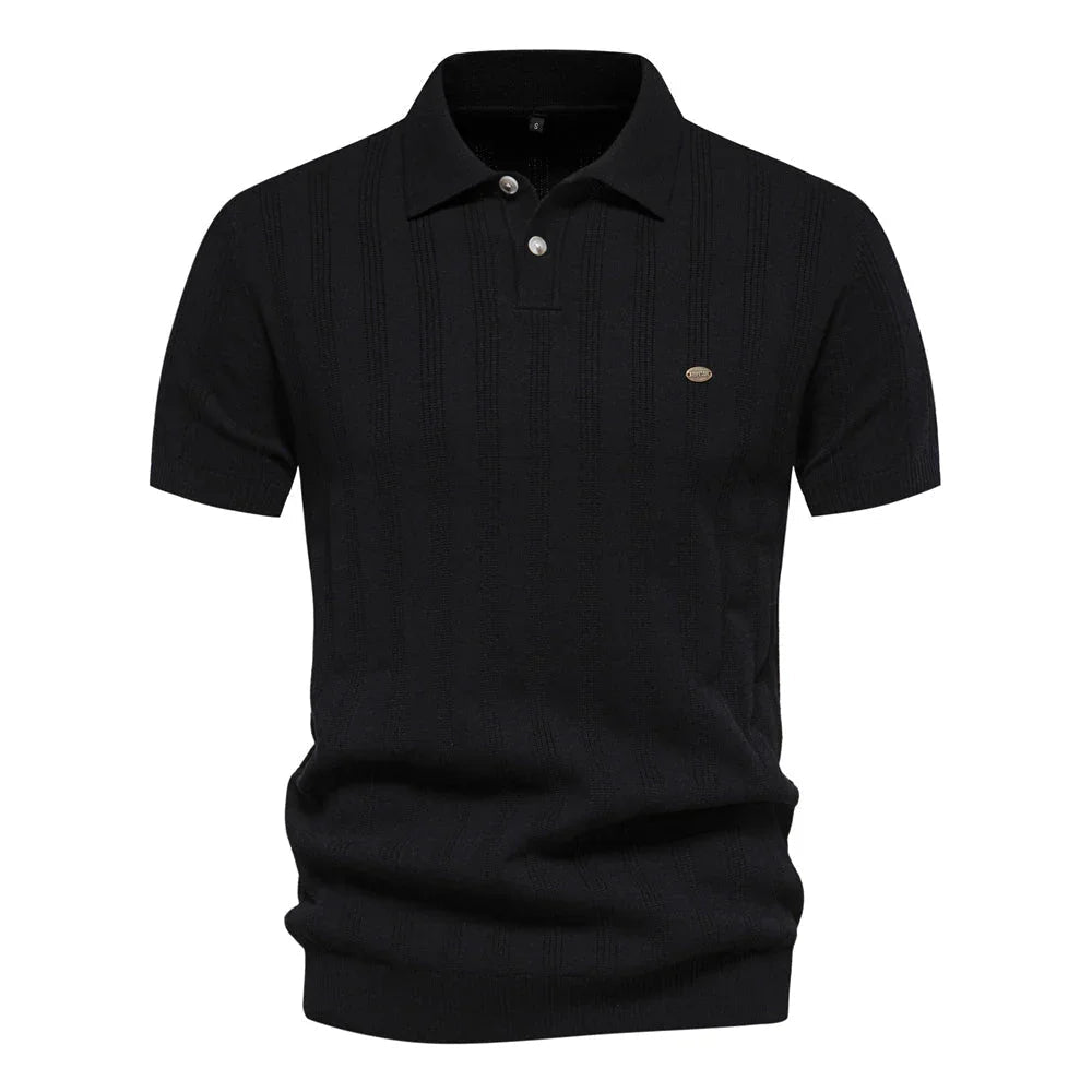 Chic summer polo shirt in black with subtle vertical stripe texture, short sleeves, chest logo.