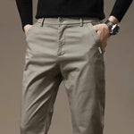Beige-gray slim chino pants with button closure and belt loops, tapered fit