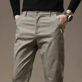Beige-gray slim chino pants with button closure and belt loops, tapered fit