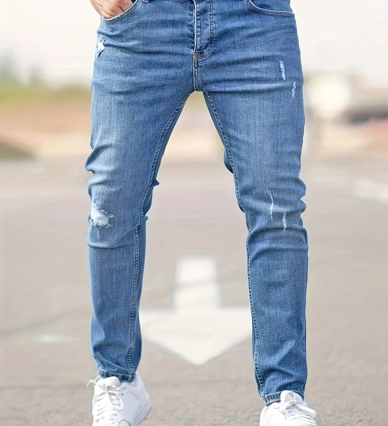Slim-fit ripped jeans in medium blue, distressed knees and tapered leg openings