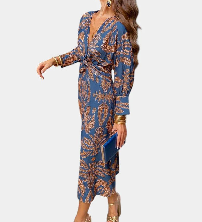 Blue long-sleeve V-neck midi dress with draped tie waist and ornate print