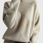 Ivory turtleneck sweater with ribbed knit and diamond pattern on the front