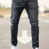 Slim-fit ripped jeans in black wash, distressed knees and fitted straight legs