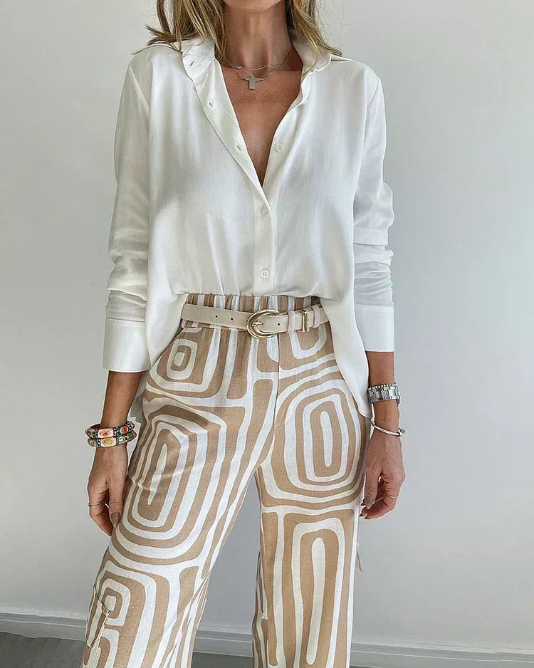 Two-piece outfit: light blouse with open V-neck and belt; cream patterned wide-leg pants