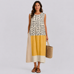 Sleeveless color-block summer dress with cream polka-dot top, yellow band, and beige skirt