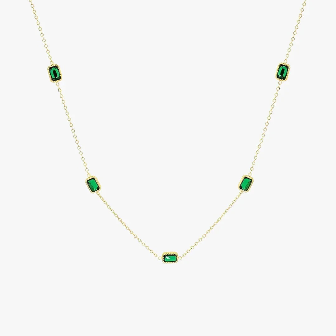 Gold chain necklace with evenly spaced green rectangular stones on a long chain.