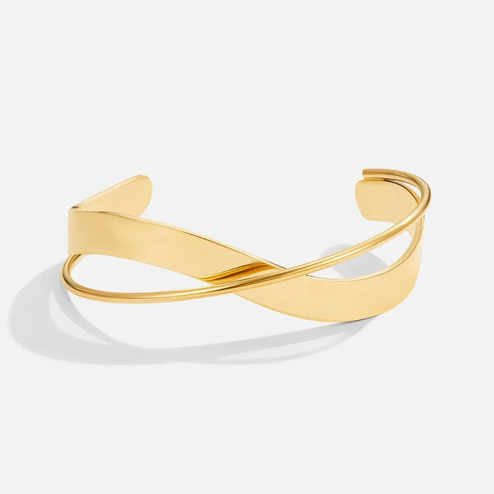 Gold open cuff bracelet with curved bar design and slim hinged band.