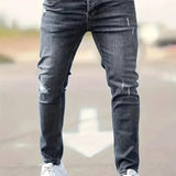 Slim-fit ripped jeans in medium blue, distressed knees and raw hems