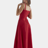 Red midi dress with spaghetti straps, ruched bodice, and flared knee-length skirt