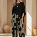 Black asymmetrical top with flutter sleeves and wide-leg boho pants in black-on-cream dot print