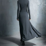 Dark long-sleeve draped maxi dress, back view, fitted waist with extended skirt drape