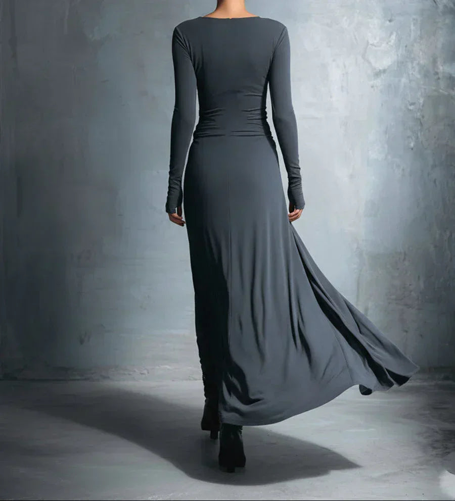 Dark long-sleeve draped maxi dress, back view, fitted waist with extended skirt drape