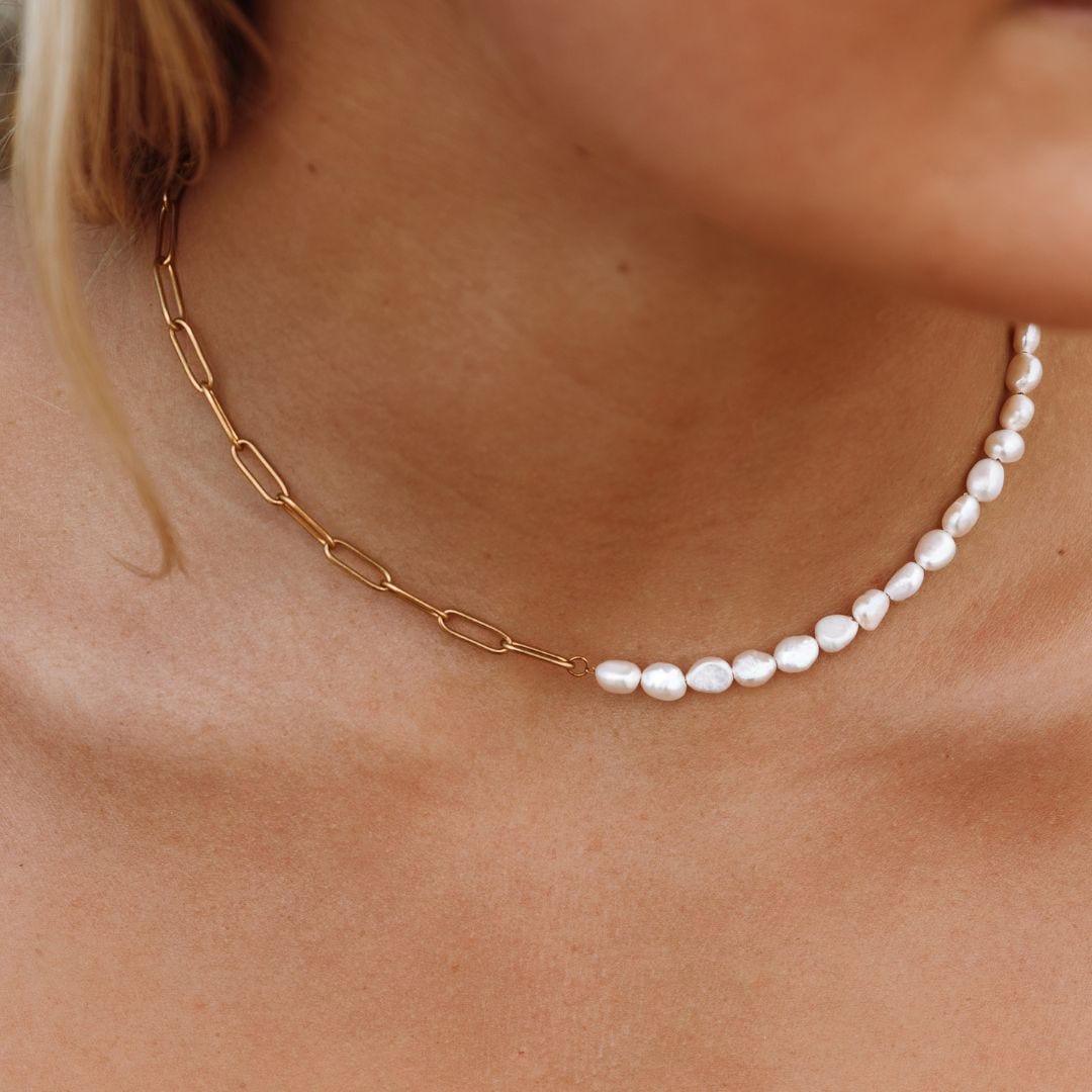 Gold link necklace with a row of small white pearl beads