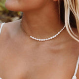 Gold chain choker-style necklace with small white pearl beads