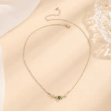 Silver-tone chain necklace with small green emerald center charm