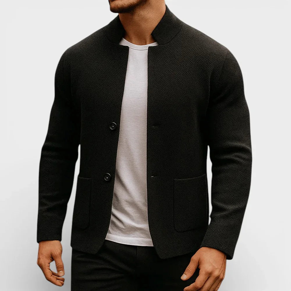Black knit blazer with two-button front and flap pockets