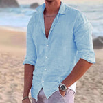 Men's casual button-up shirt, light blue, 3/4 sleeves, open collar.
