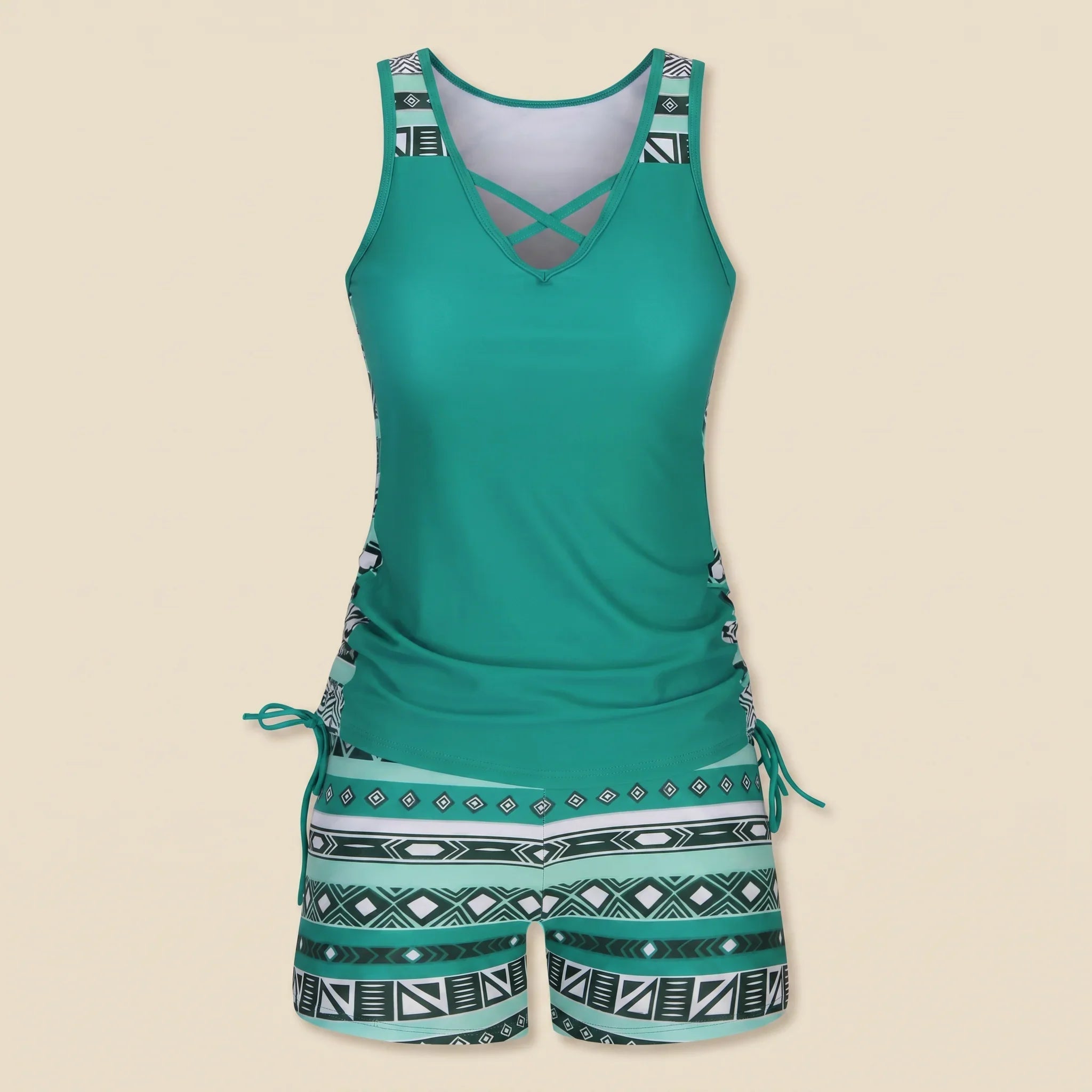 Green-teal tankini set with crisscross V-neck and teal-and-black geometric drawstring shorts