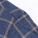 Navy checkered dress shirt fabric with tan grid pattern, front panel close-up.