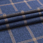 Folded navy checkered dress shirt fabric showing tan grid pattern.