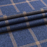 Folded navy checkered dress shirt fabric showing tan grid pattern.