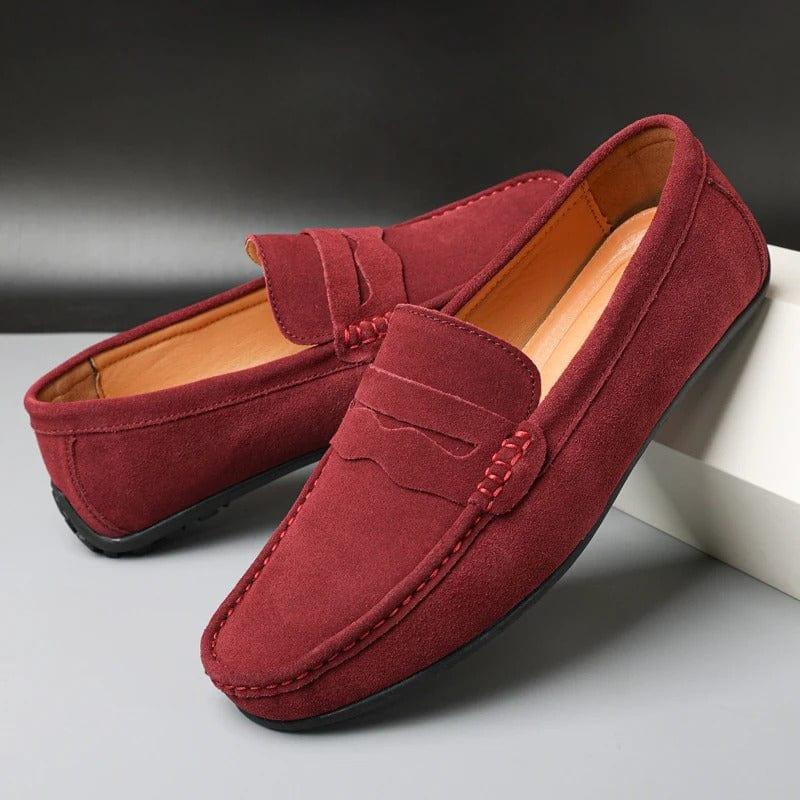 Burgundy suede loafers with slip-on strap and moc toe stitching