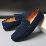 Navy blue suede slip-on loafers with tassel-free stitched strap and rubber sole