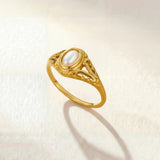 Gold oval-pearl ring with ornate filigree setting