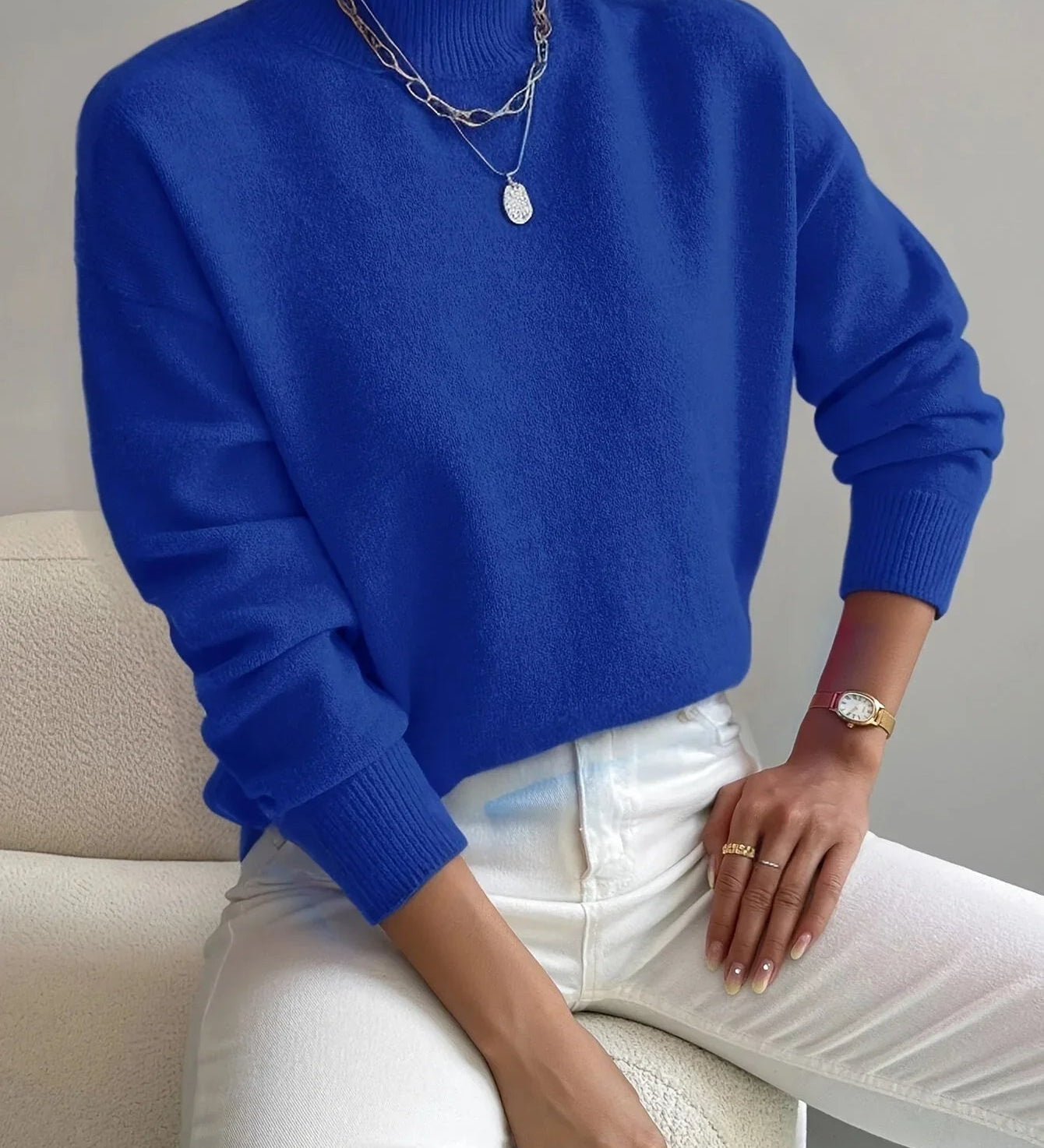 Blue knit crewneck sweater with long sleeves and ribbed cuffs and hem