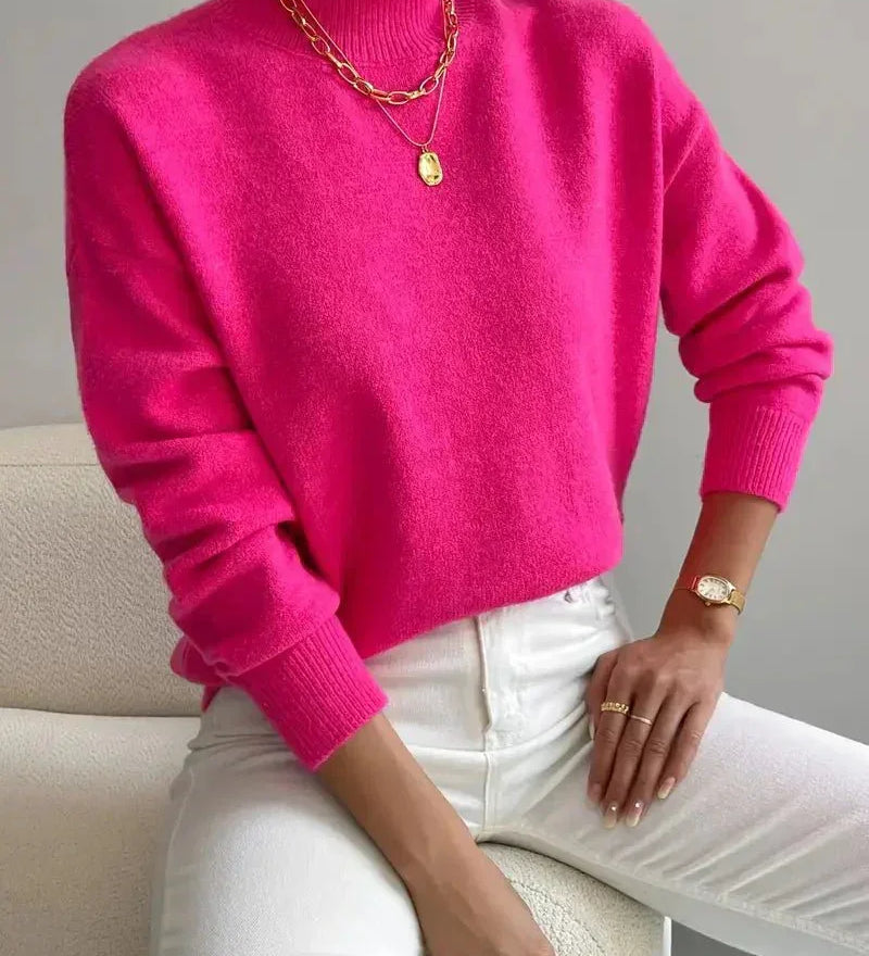 Bright pink knit crewneck sweater with long sleeves and ribbed cuffs and hem