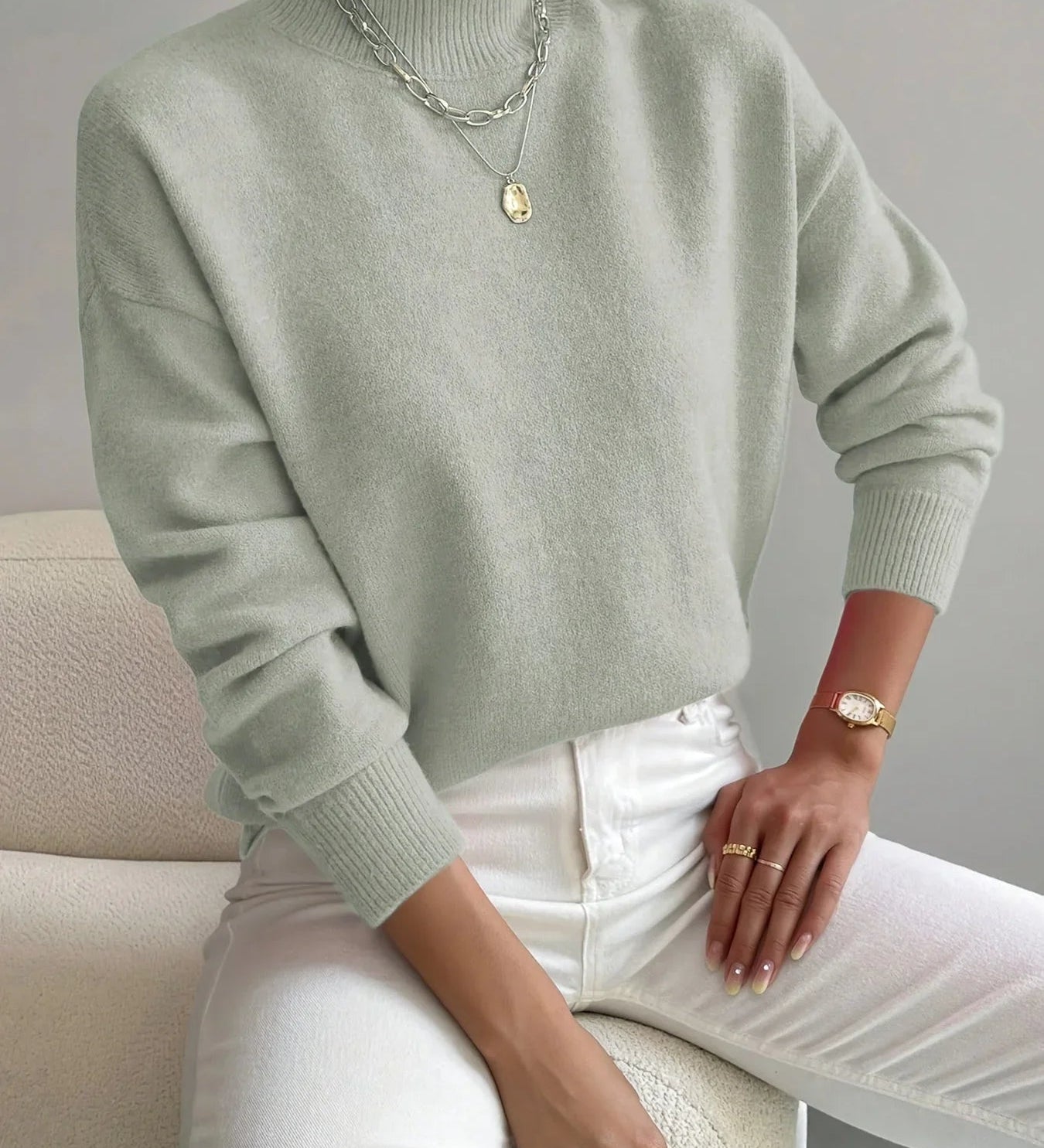 Light green crewneck sweater with long sleeves and ribbed cuffs