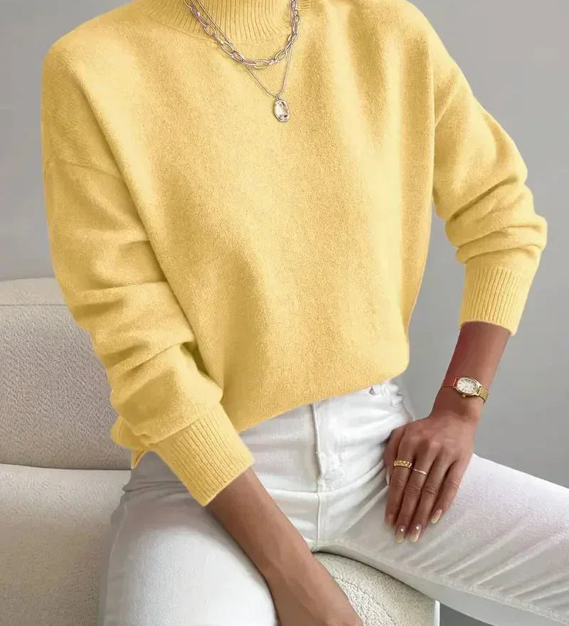 Yellow knit crewneck sweater with long sleeves and ribbed cuffs and hem