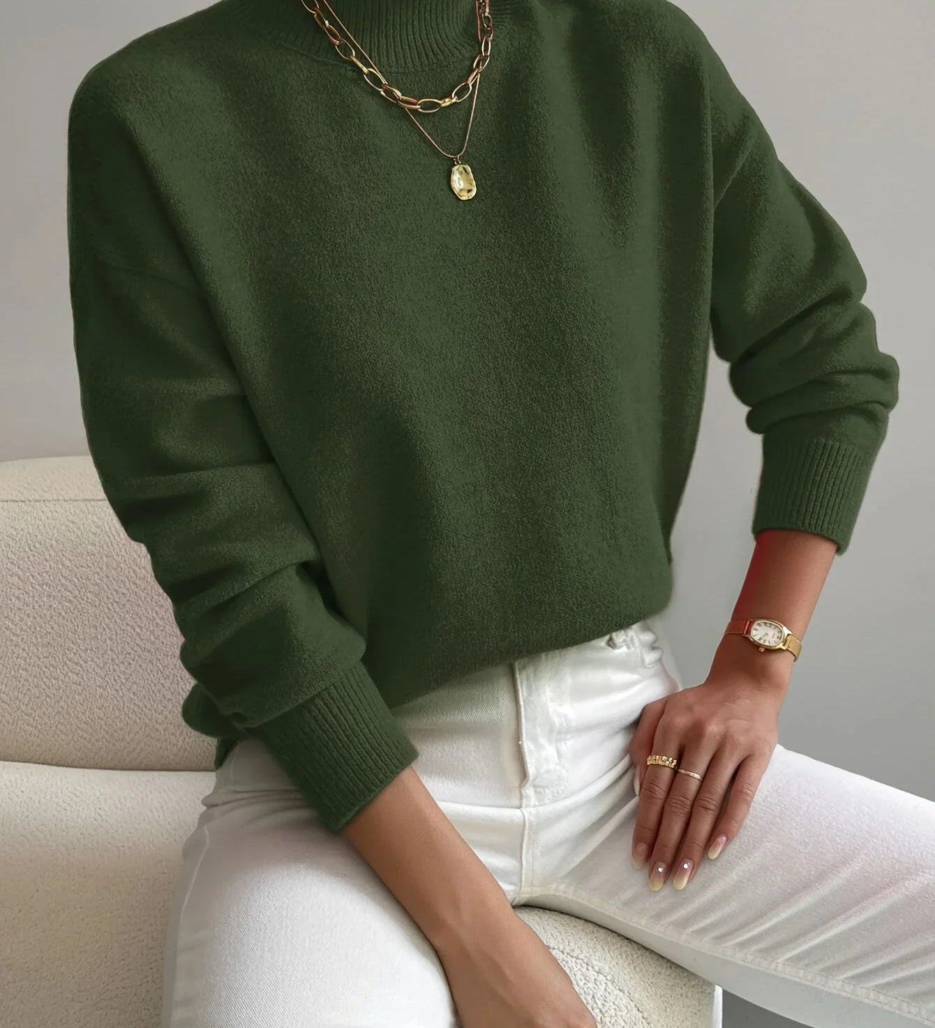 Green knit crewneck sweater with long sleeves and ribbed cuffs and hem