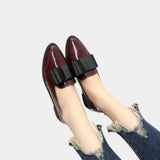 Burgundy loafers with black buckle strap, worn with denim