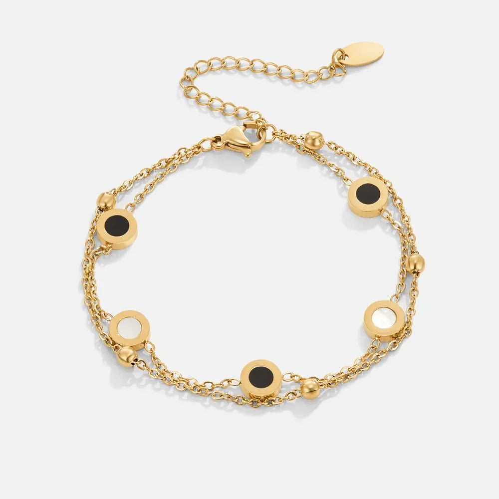 Gold chain bracelet with black and white round stone charms and lobster clasp