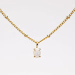 Gold opal pendant necklace with link chain and round opal centerpiece