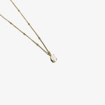 Gold opal pendant necklace with oval opal charm on beaded link chain