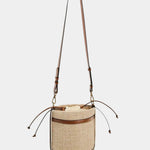 Brown knitted cylinder bucket bag with braided straps and leather trim