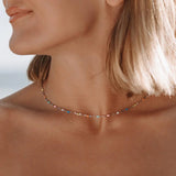 Gold-tone delicate choker necklace with multicolor stones at neckline