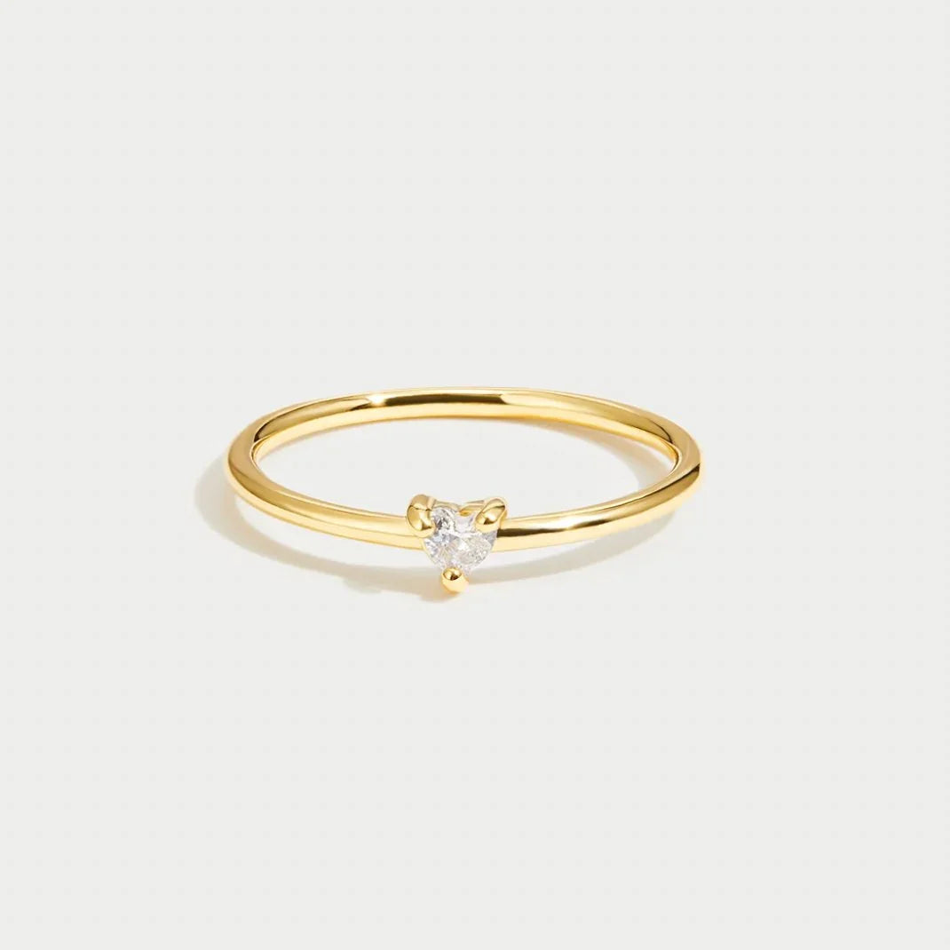 Gold smooth band ring with small clear stone on top
