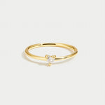Gold smooth band ring with small clear stone on top