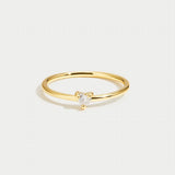 Gold smooth band ring with small clear stone on top