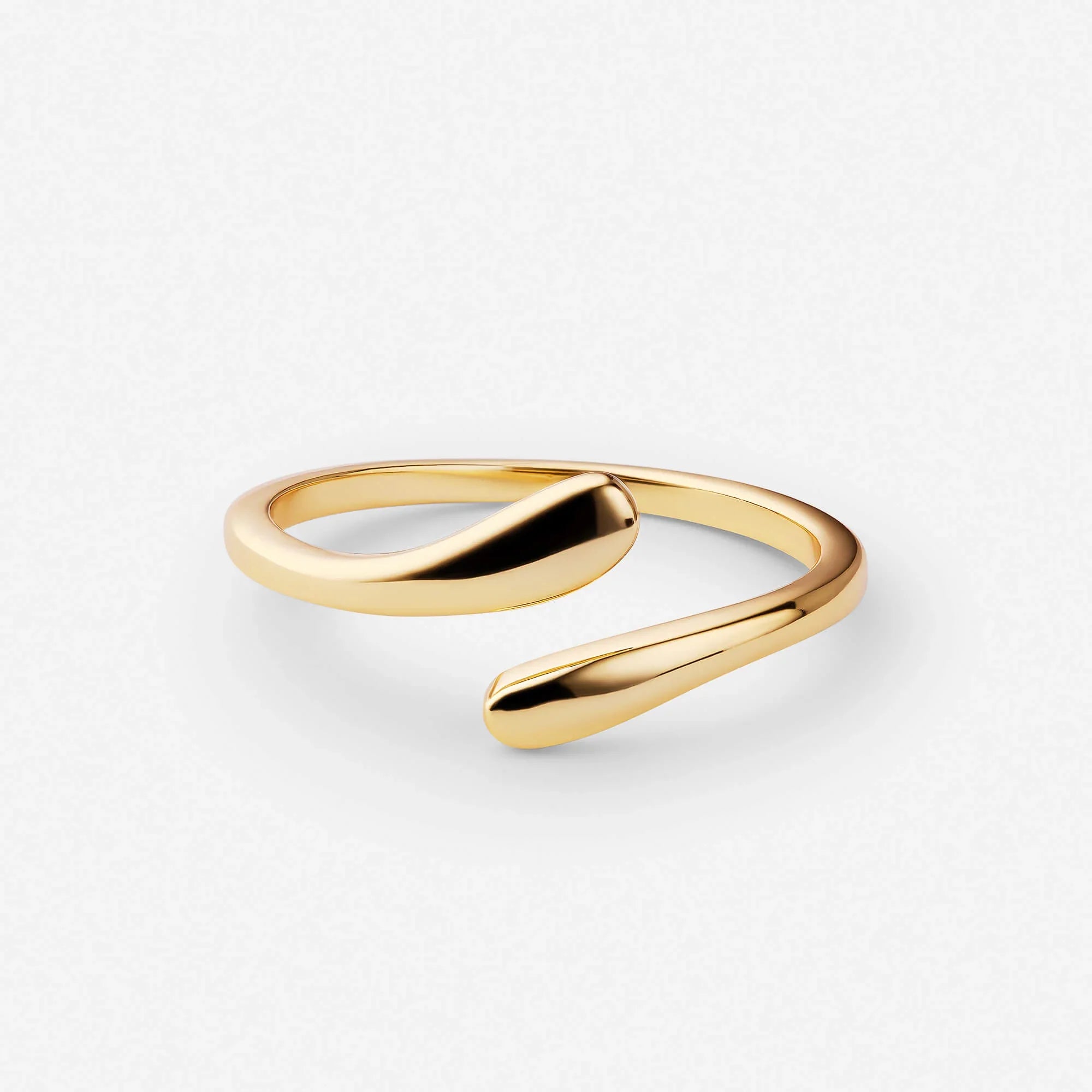 Gold open band ring with smooth twisted shape and dark center insert